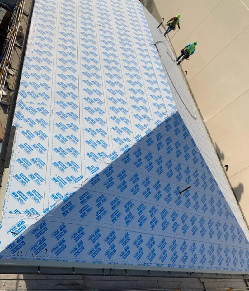 Professional roofers installing underlayment on a metal roof in Hastings